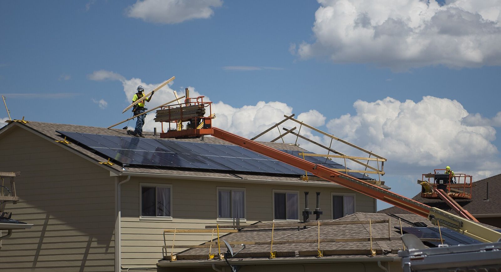 Northside Family Roofing lift and crew on a one-story roof in Norwood Park